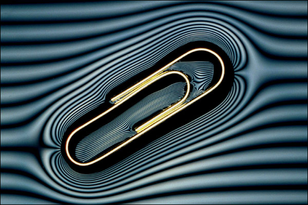 A paperclip floating on water.
